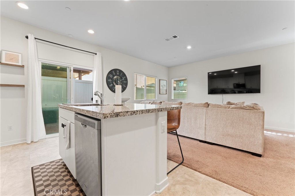 12704 Ironstone Way Moreno Valley, CA 92555 - Photo 26 of 38 a living room with furniture and a flat screen tv