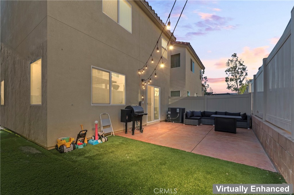 12704 Ironstone Way Moreno Valley, CA 92555 - Photo 30 of 38 a view of a patio with couches table and chairs and potted plants