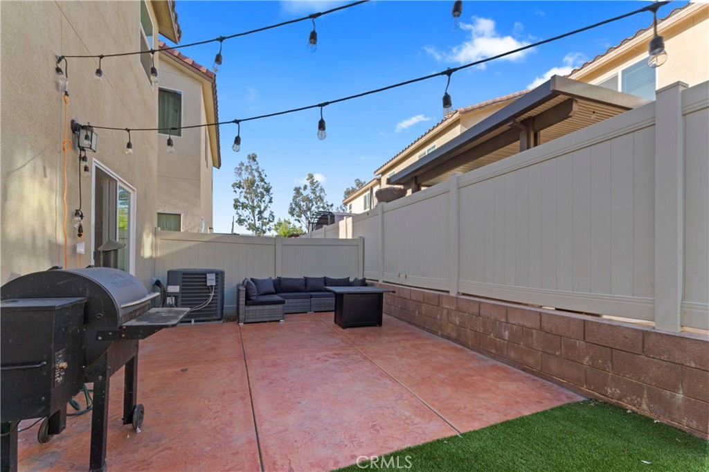 12704 Ironstone Way Moreno Valley, CA 92555 - Photo 31 of 38 a backyard of a house with outdoor seating