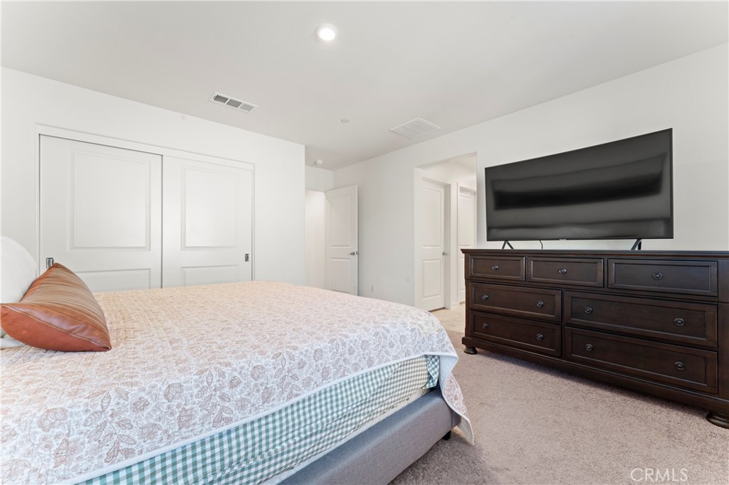 12704 Ironstone Way Moreno Valley, CA 92555 - Photo 6 of 38 a bedroom with a bed and a flat screen tv