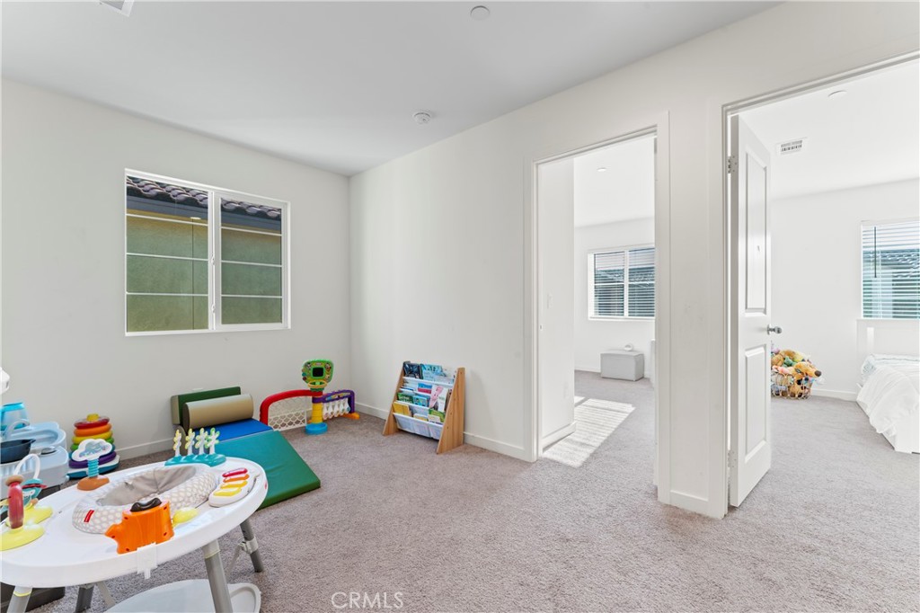 12704 Ironstone Way Moreno Valley, CA 92555 - Photo 8 of 38 a children room with furniture and a window