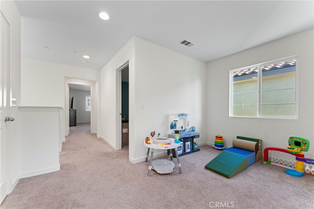 12704 Ironstone Way Moreno Valley, CA 92555 - Photo 9 of 38 a room with furniture and white walls