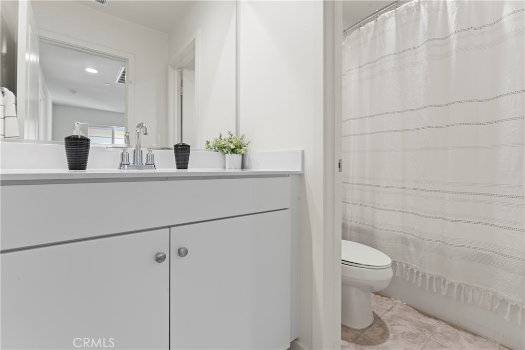 12704 Ironstone Way Moreno Valley, CA 92555 - Photo 10 of 38 a bathroom with a sink a toilet and shower
