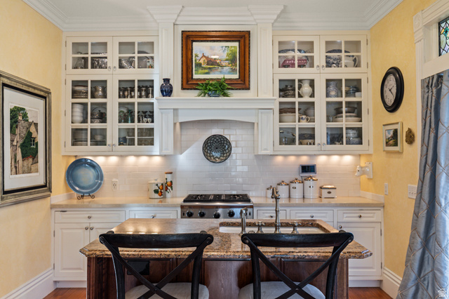 390 North 100 West Monroe, UT 84754 - Photo 5 of 167 Kitchen featuring white cabinets, glass insert cabinets, tasteful backsplash, and ornamental molding