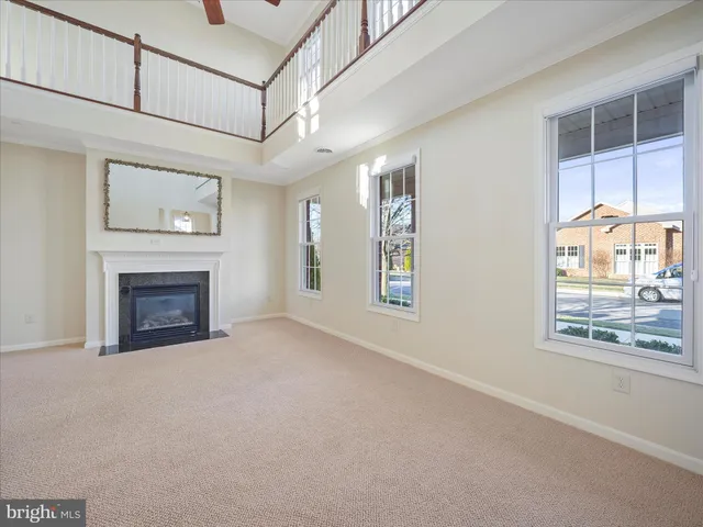 a living room with a fireplace and a floor to ceiling window