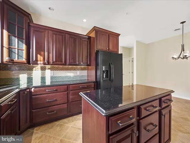 a kitchen with wooden cabinets a sink and a stove with wooden floor