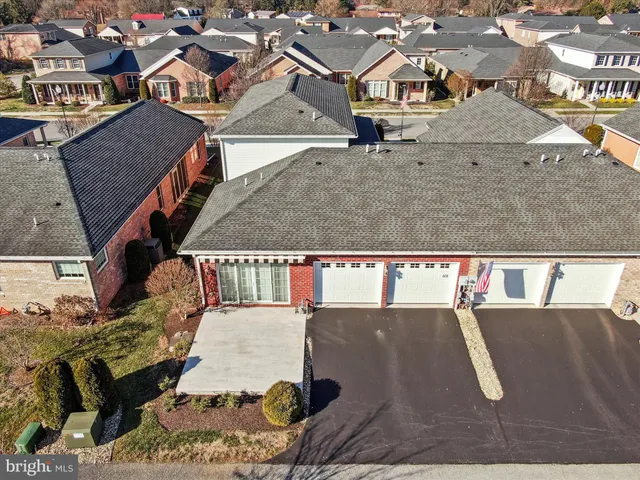 an aerial view of residential houses with outdoor space and swimming pool