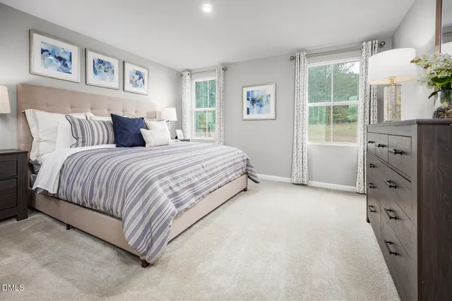 a bedroom with a large bed and a dresser