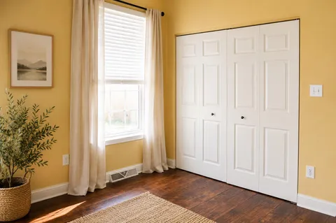 a bedroom with a bed and a dresser