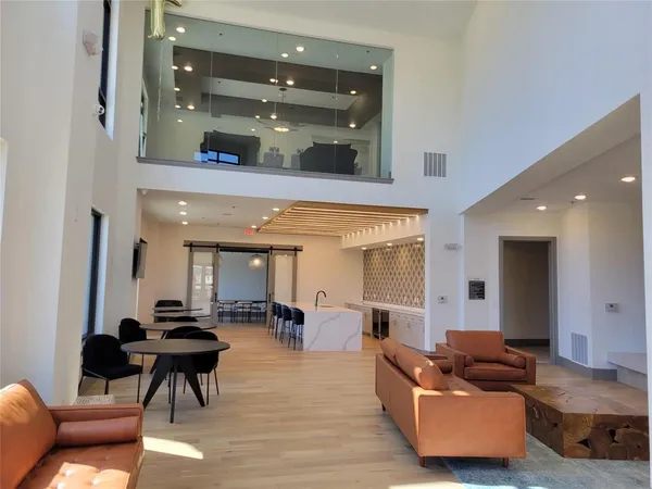 a living room with furniture and a glass door