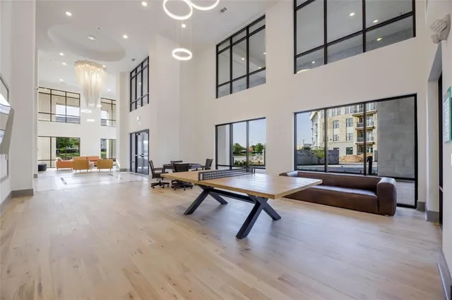 a living room with patio furniture and a table