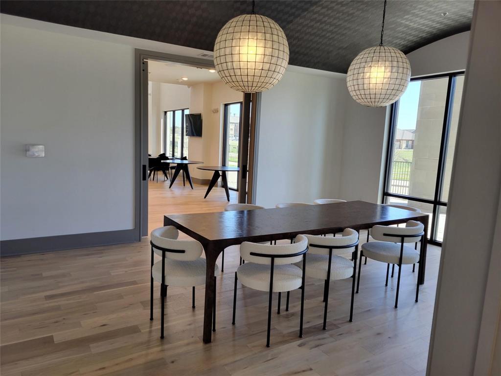 2700 Old Denton Road, Unit 3362 Carrollton, TX 75007 - Photo 16 of 19 a dining room with furniture a chandelier and wooden floor