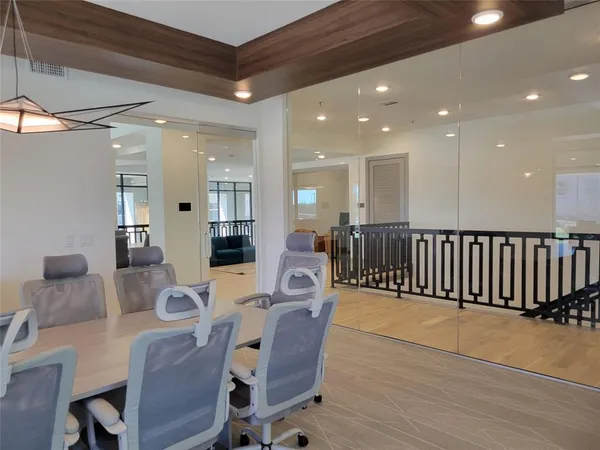 a dining room with furniture and wooden floor