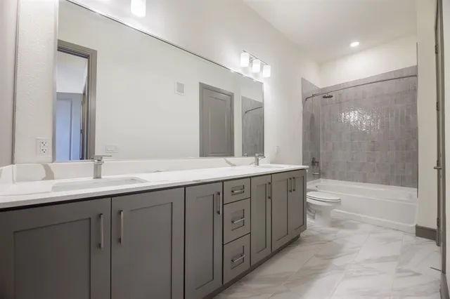 a bathroom with double sink and a mirror