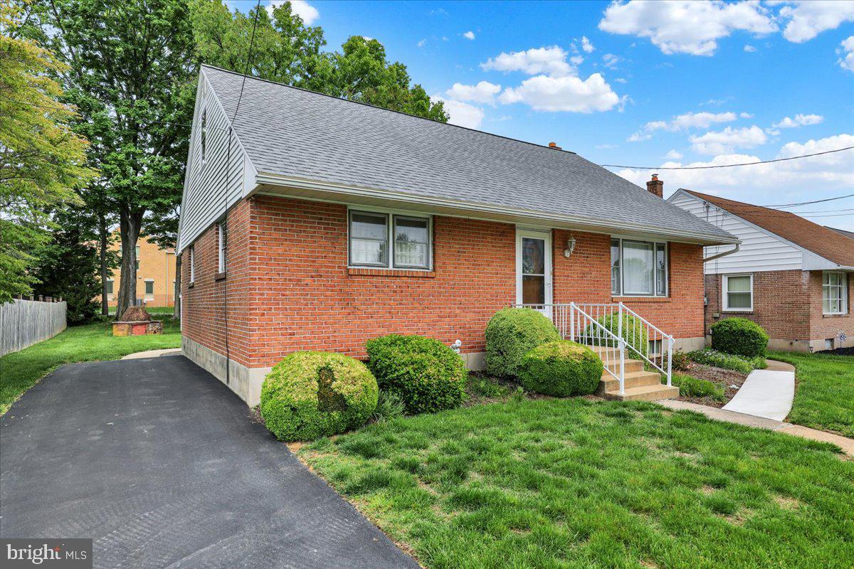1224 Commonwealth Boulevard Reading, PA 19607 - Photo 4 of 27 a brick house with potted plants in front of it