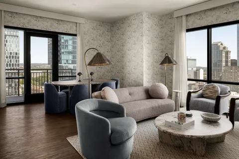 a living room with furniture and a floor to ceiling window