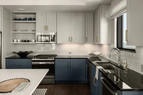 a kitchen with stainless steel appliances a stove a sink and cabinets