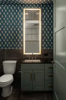 a bathroom with a toilet a sink and a window