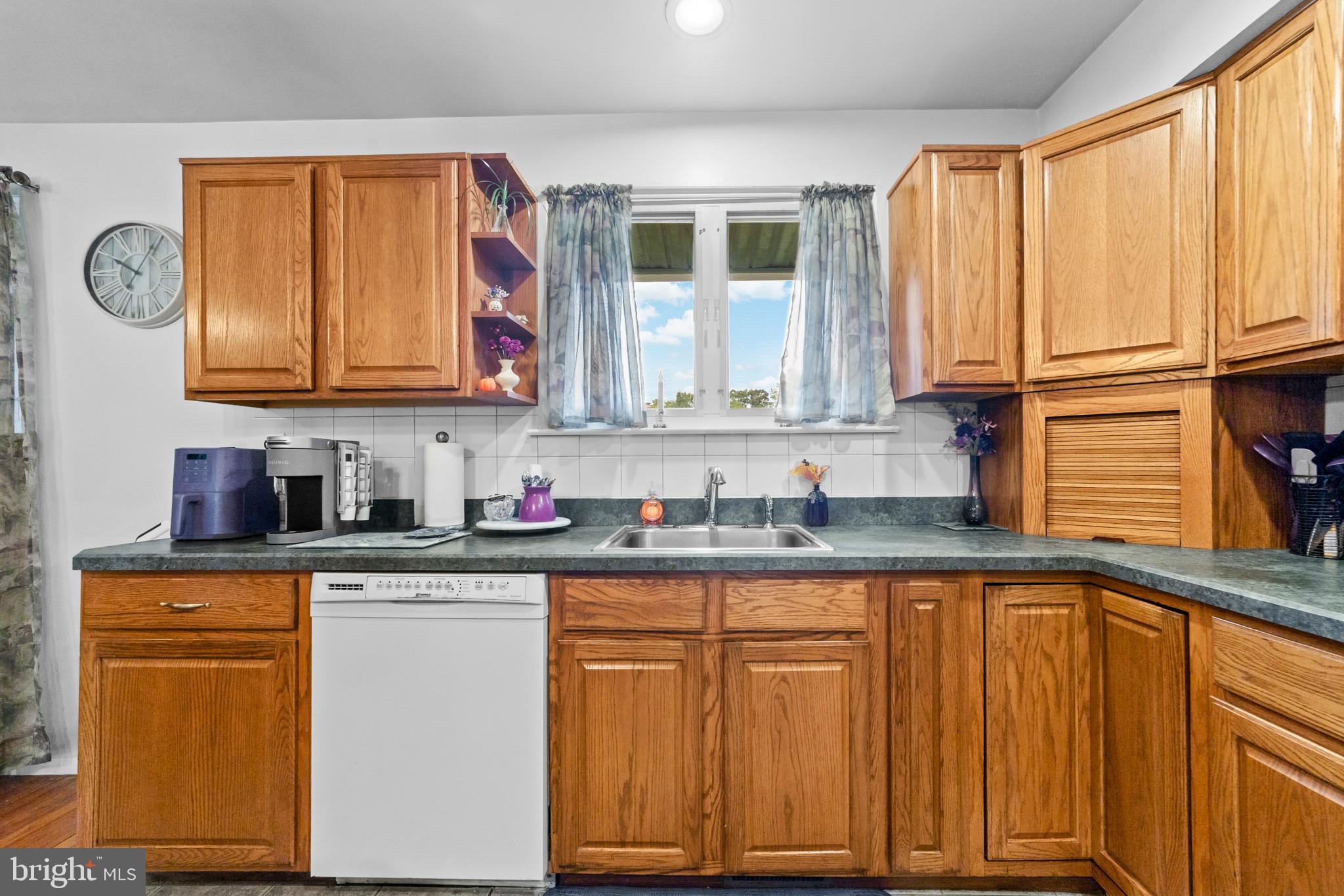 1606 Gordon Road Burlington, NJ 08016 - Photo 12 of 35 a kitchen with granite countertop wooden cabinets stainless steel appliances a sink and a window
