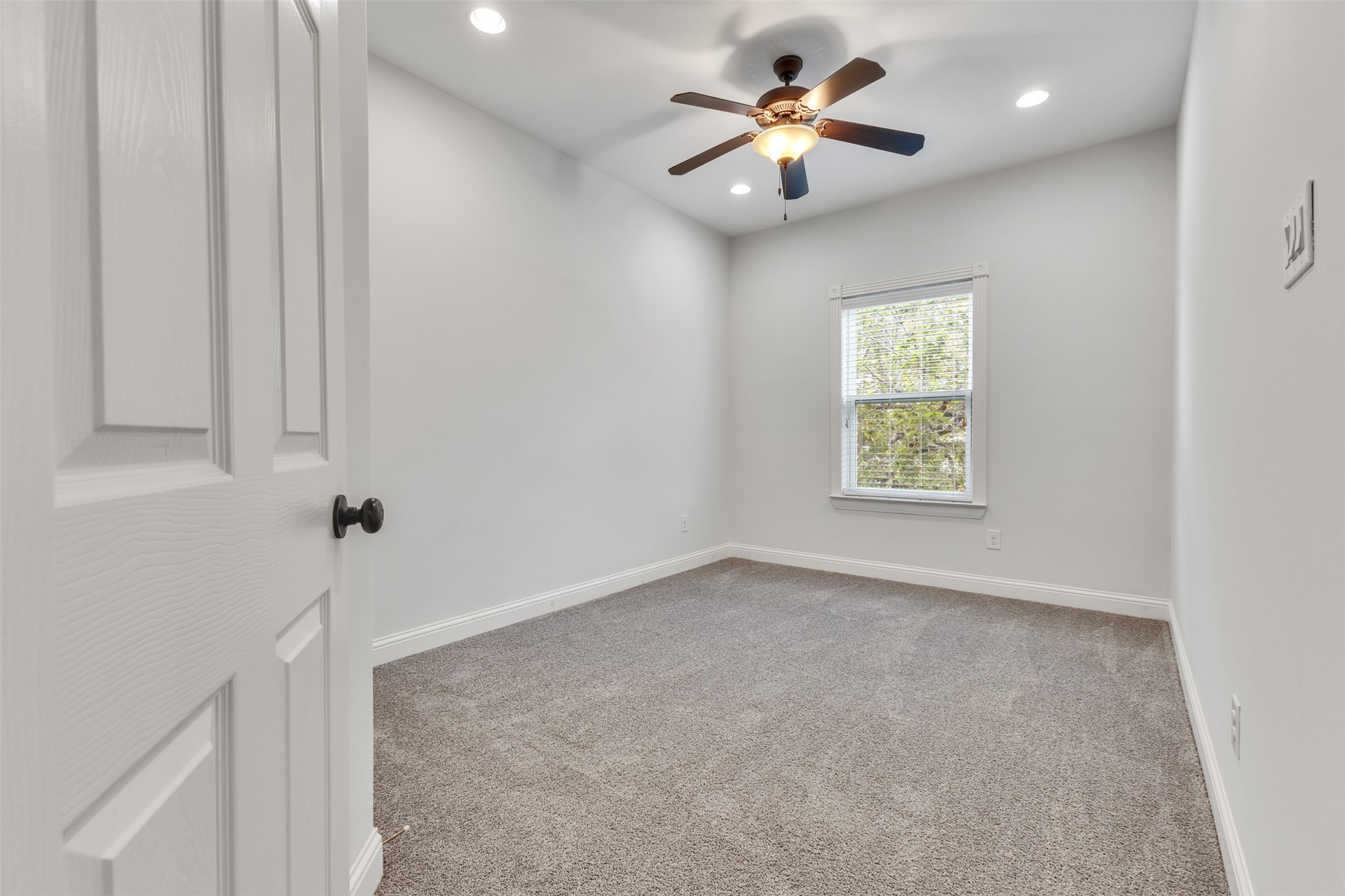 3911 Kennon Street, Unit A Houston, TX 77009 - Photo 7 of 14 an empty room with a window and a fan