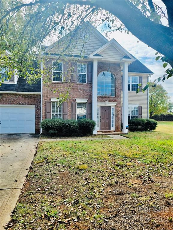 11402 Woodfire Road Charlotte, NC 28269 - Photo 1 of 24 a front view of a house with a garden