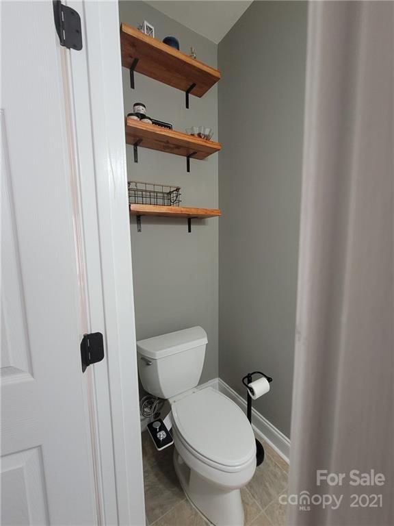 11402 Woodfire Road Charlotte, NC 28269 - Photo 11 of 24 a white toilet sitting next to a shower