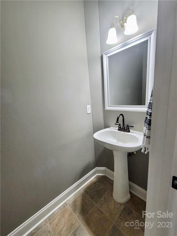 11402 Woodfire Road Charlotte, NC 28269 - Photo 12 of 24 a bathroom with a sink and a mirror