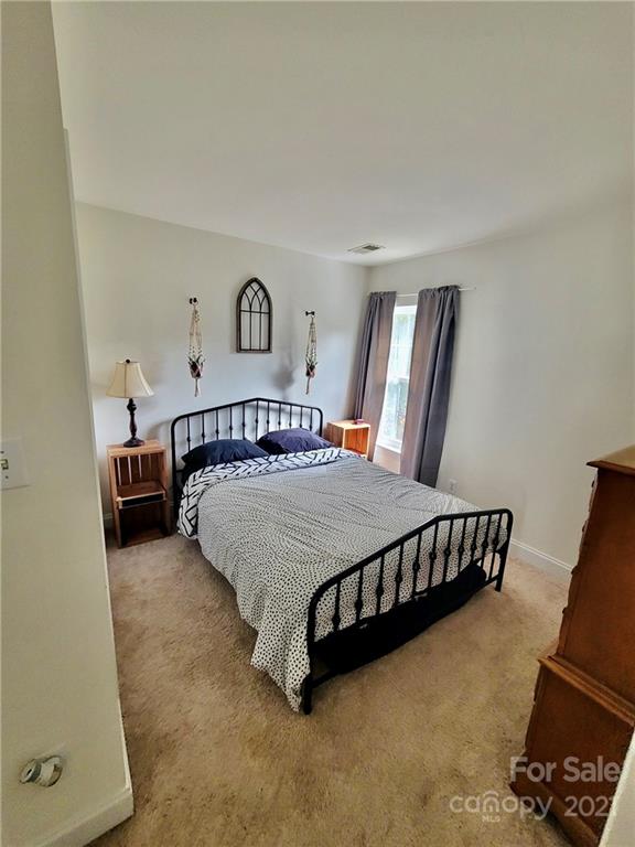 11402 Woodfire Road Charlotte, NC 28269 - Photo 18 of 24 a bedroom with a bed and window