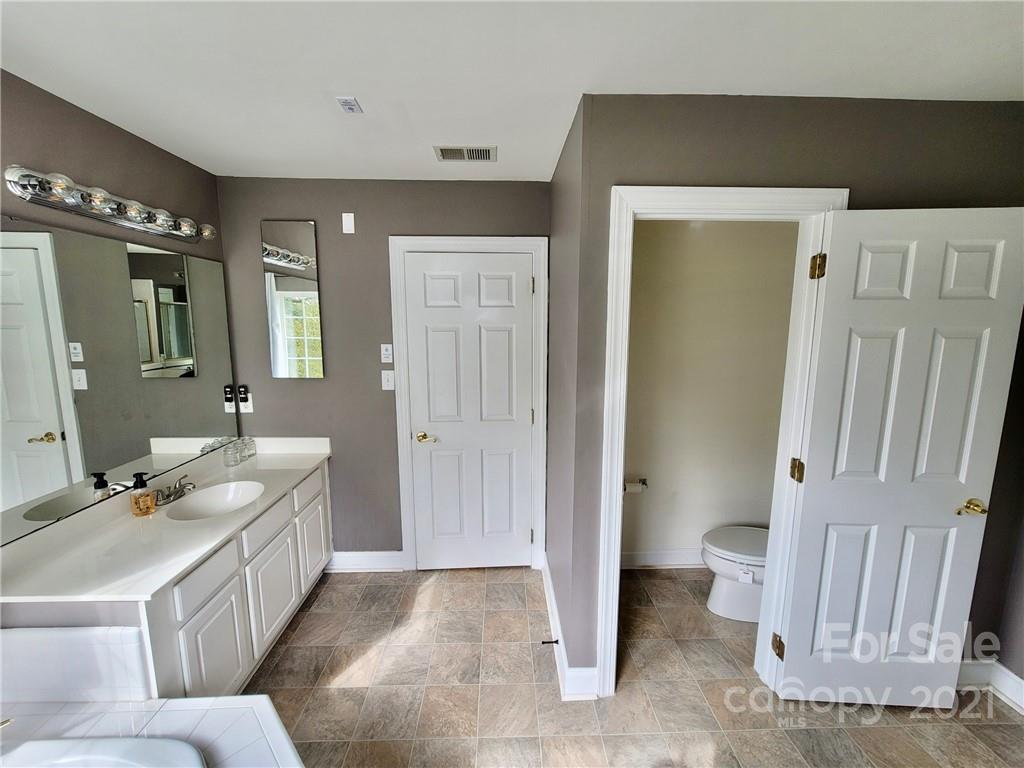 11402 Woodfire Road Charlotte, NC 28269 - Photo 19 of 24 a bathroom with a double vanity sink and mirror