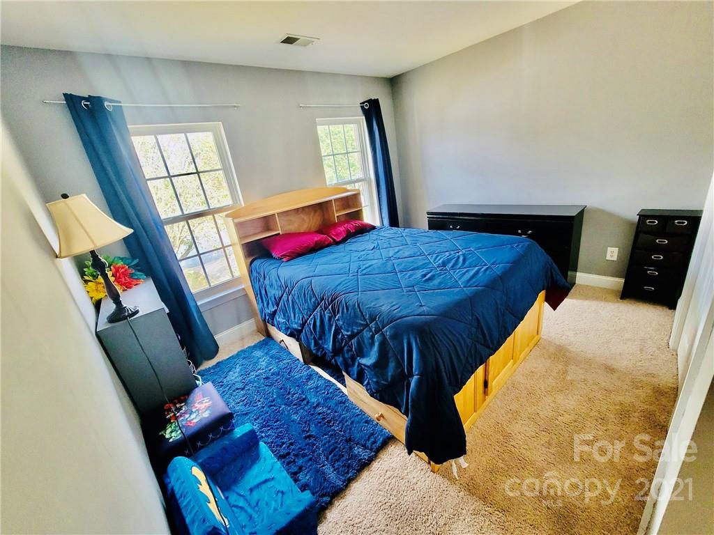 11402 Woodfire Road Charlotte, NC 28269 - Photo 22 of 24 a bedroom with a bed and a window