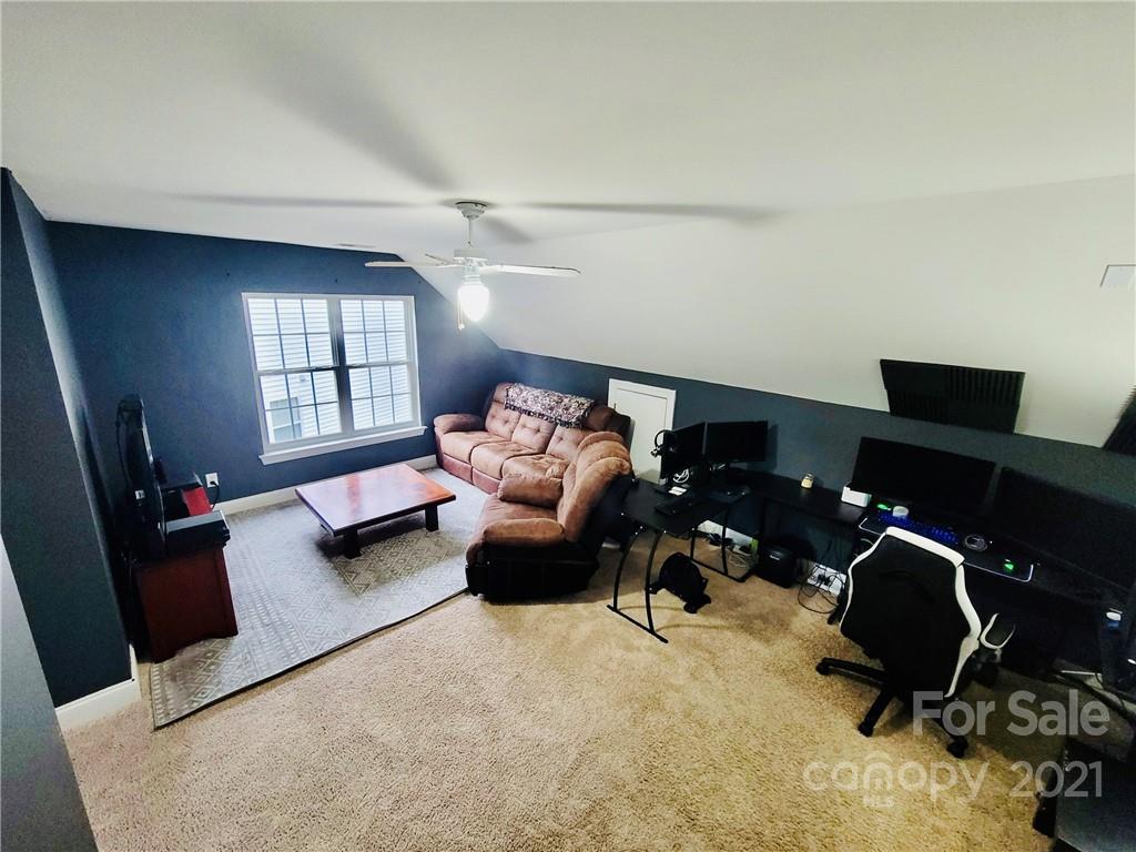 11402 Woodfire Road Charlotte, NC 28269 - Photo 23 of 24 a livingroom with workspace and a couch