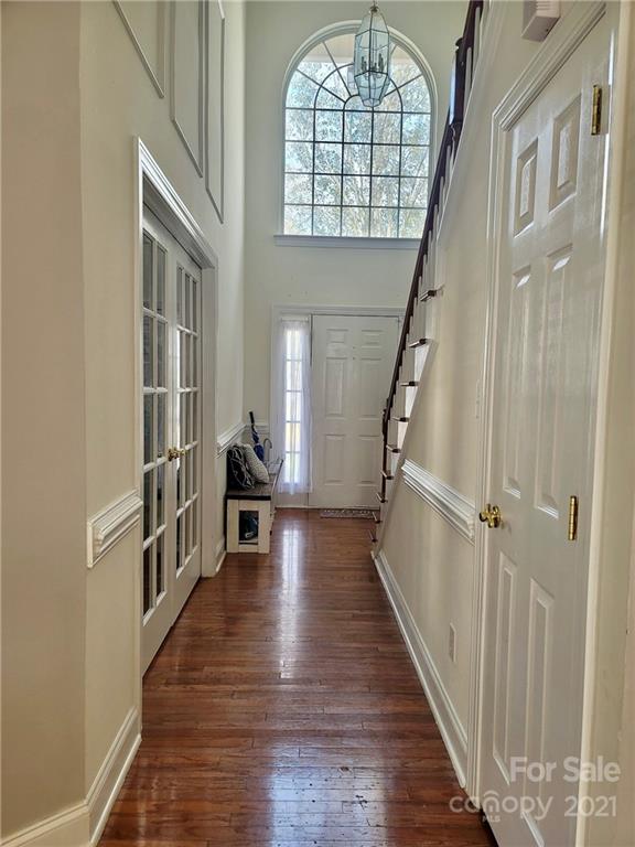 11402 Woodfire Road Charlotte, NC 28269 - Photo 3 of 24 a view of an entryway with wooden floor windows and a chandelier