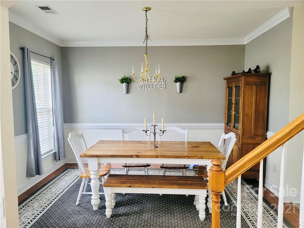 11402 Woodfire Road Charlotte, NC 28269 - Photo 4 of 24 a bed sitting in a room next to a window