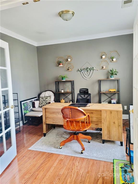 11402 Woodfire Road Charlotte, NC 28269 - Photo 6 of 24 a living room with furniture a rug and gym equipment