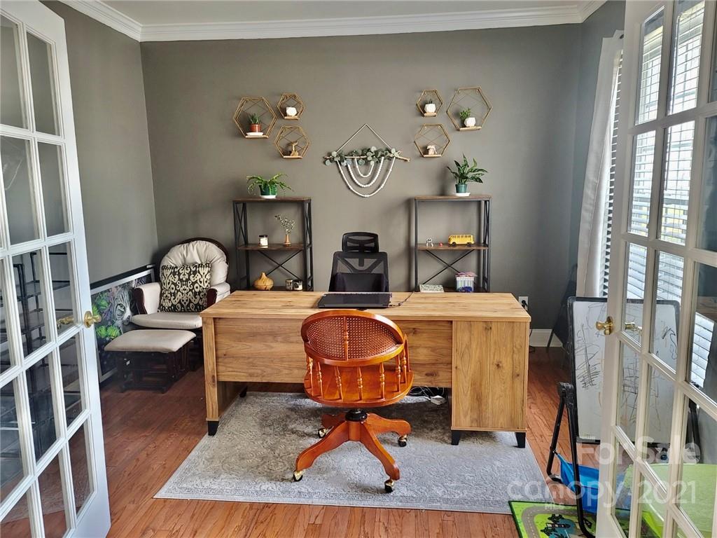 11402 Woodfire Road Charlotte, NC 28269 - Photo 7 of 24 a living room with furniture a rug and a fireplace