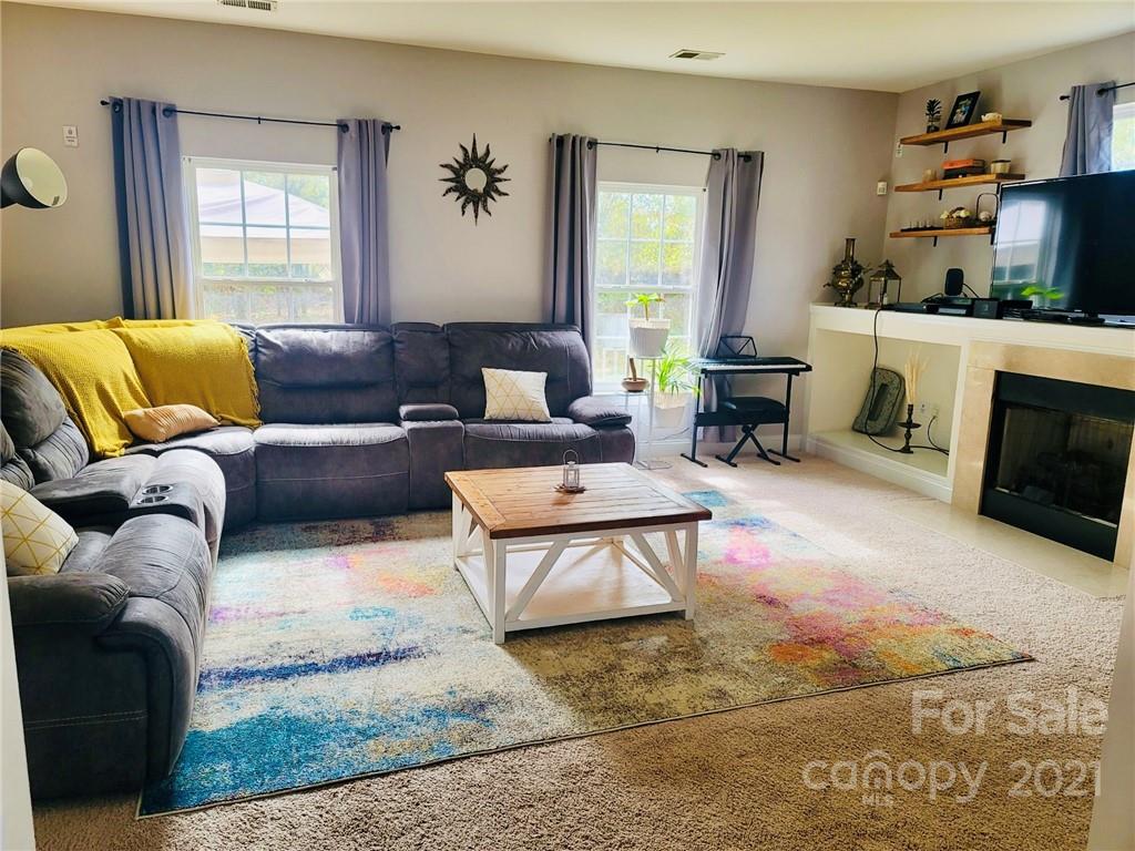 11402 Woodfire Road Charlotte, NC 28269 - Photo 8 of 24 a living room with furniture and a fireplace