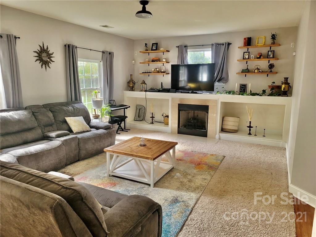 11402 Woodfire Road Charlotte, NC 28269 - Photo 9 of 24 a living room with furniture and a fireplace