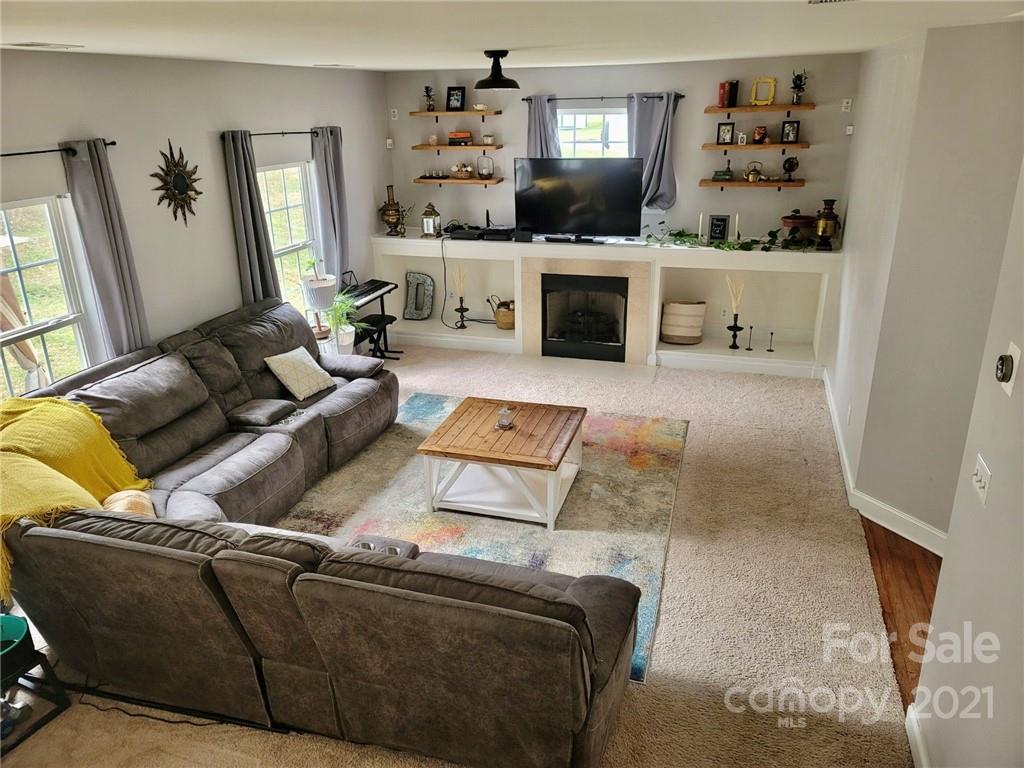 11402 Woodfire Road Charlotte, NC 28269 - Photo 10 of 24 a living room with furniture and a flat screen tv