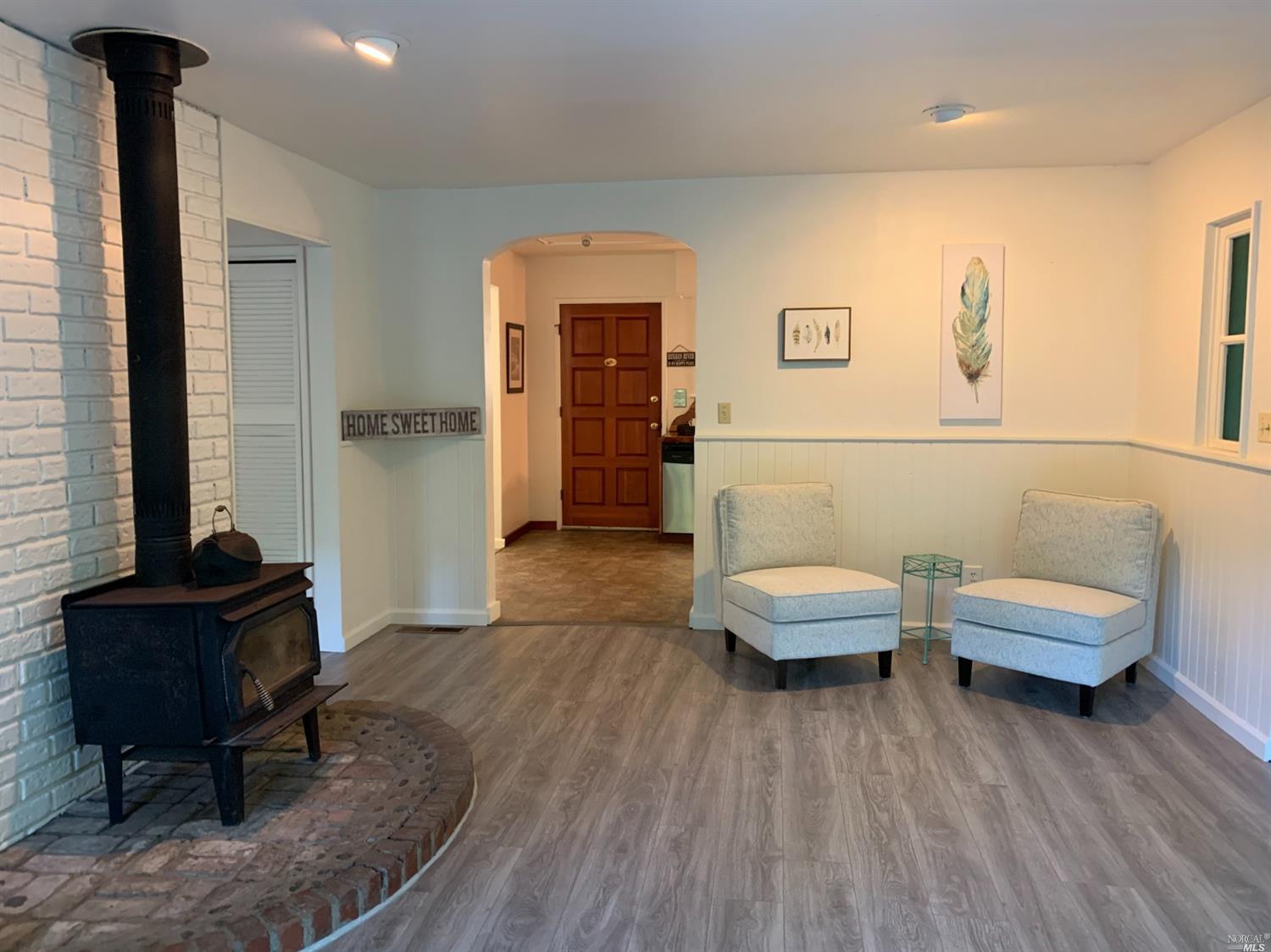 20293 Railroad Avenue Monte Rio, CA 95462 - Photo 1 of 1 a living room with furniture and a wooden floor