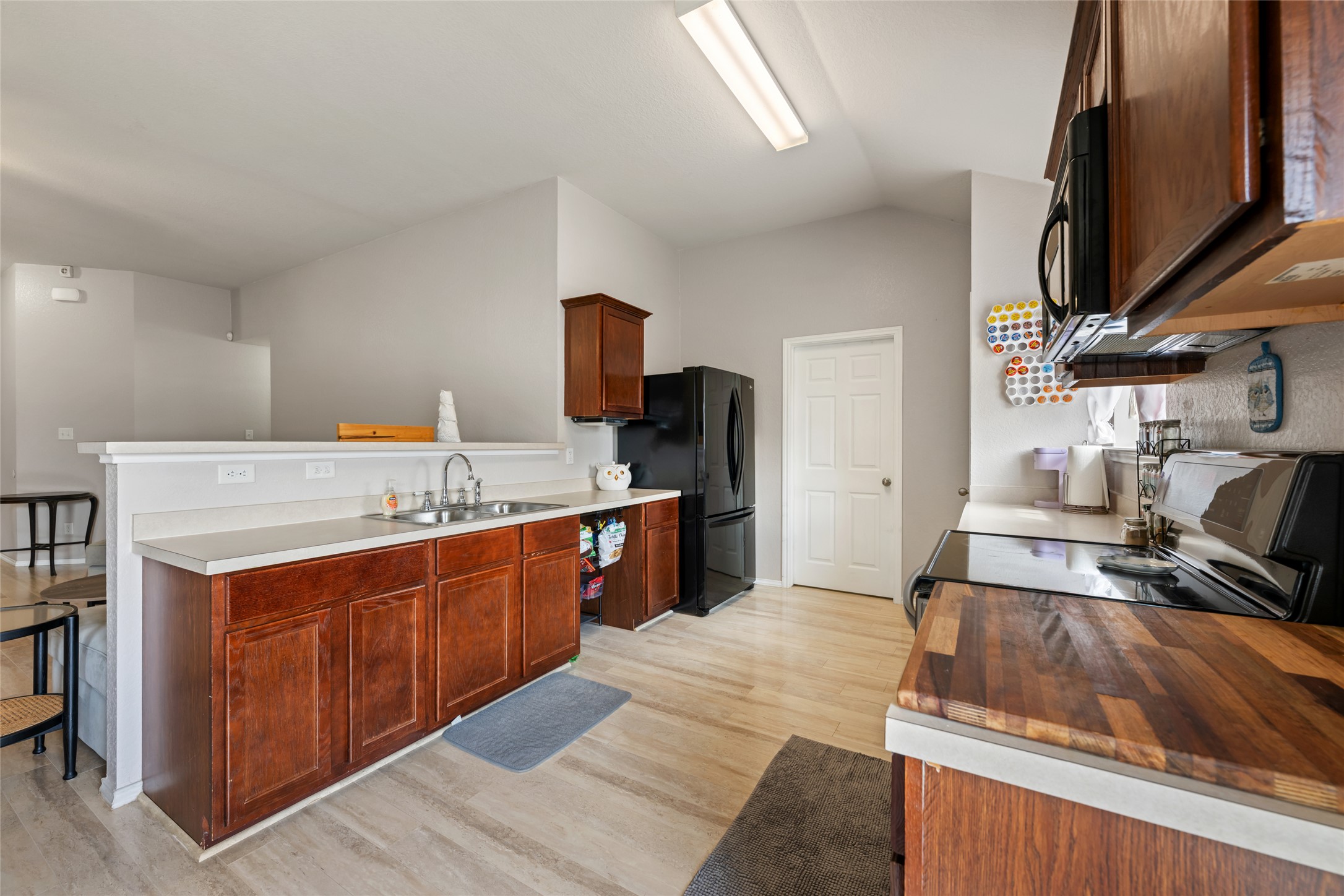 144 Calcite Lane Jarrell, TX 76537 - Photo 12 of 38 A well-equipped kitchen features a range, microwave, and ample counter space for culinary endeavors.