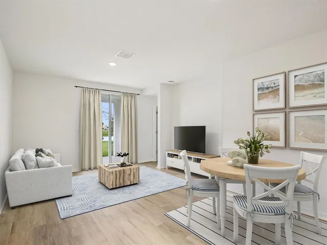 a living room with furniture a window and a flat screen tv
