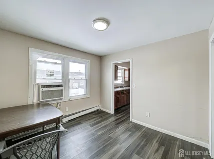 a view of a room with wooden floor lounge chair and a fireplace