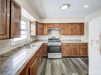 a view of kitchen with furniture and a refrigerator