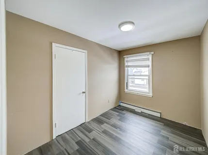 a view of an empty room and wooden floor