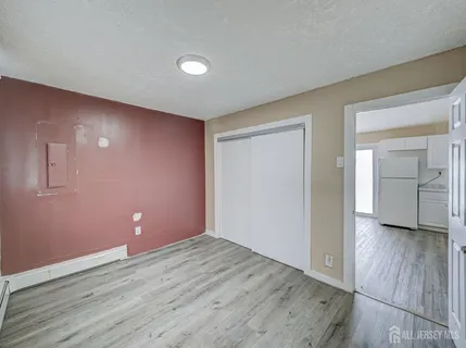 a view of a kitchen with wooden floor and electronic appliances