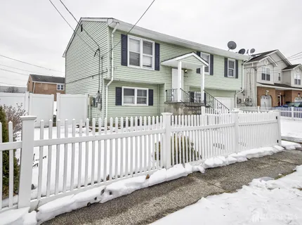 a front view of a house with wooden fence