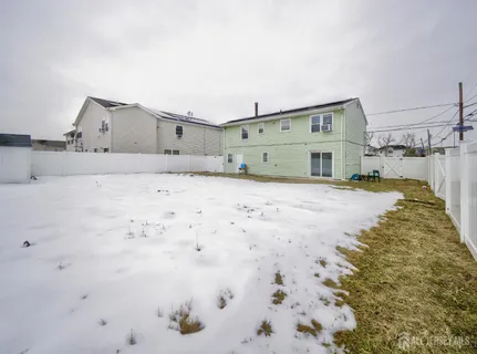 a view of a house with wooden fence