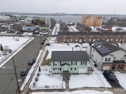an aerial view of a house with a road