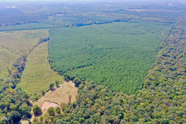 a view of a field with an ocean view