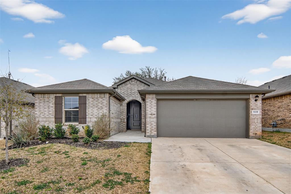 536 Bronze Circle East Springtown, TX 76082 - Photo 1 of 28 a front view of a house with a yard and garage